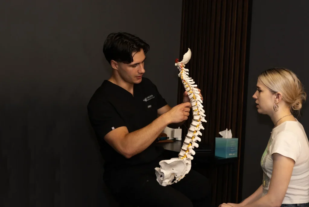 Chiropractor Josh Newsom explaining findings with a spine model at Ancoats Chiropractic Clinic